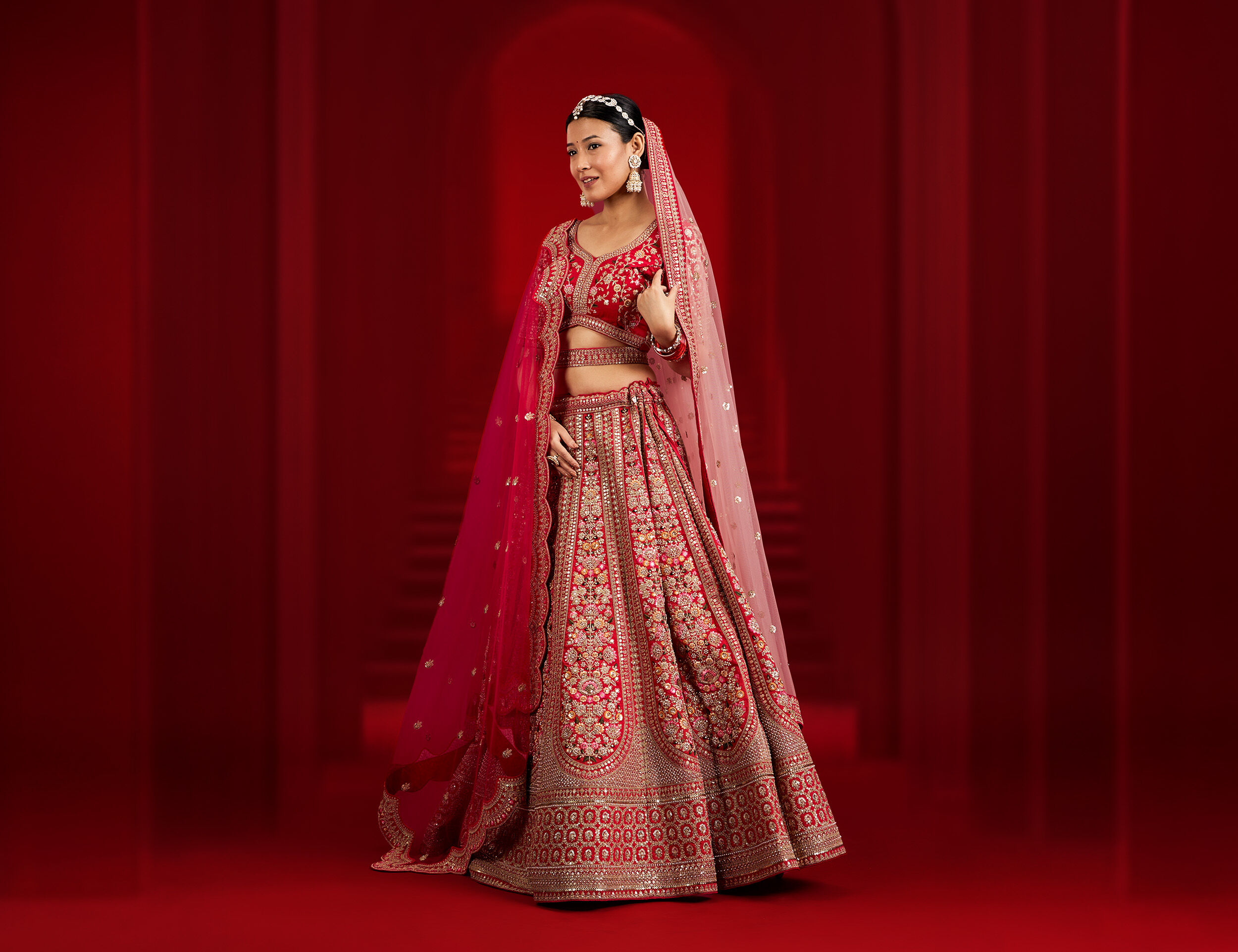 Bride wearing a beautiful pink lehenga paired with gracefully draped double dupattas.